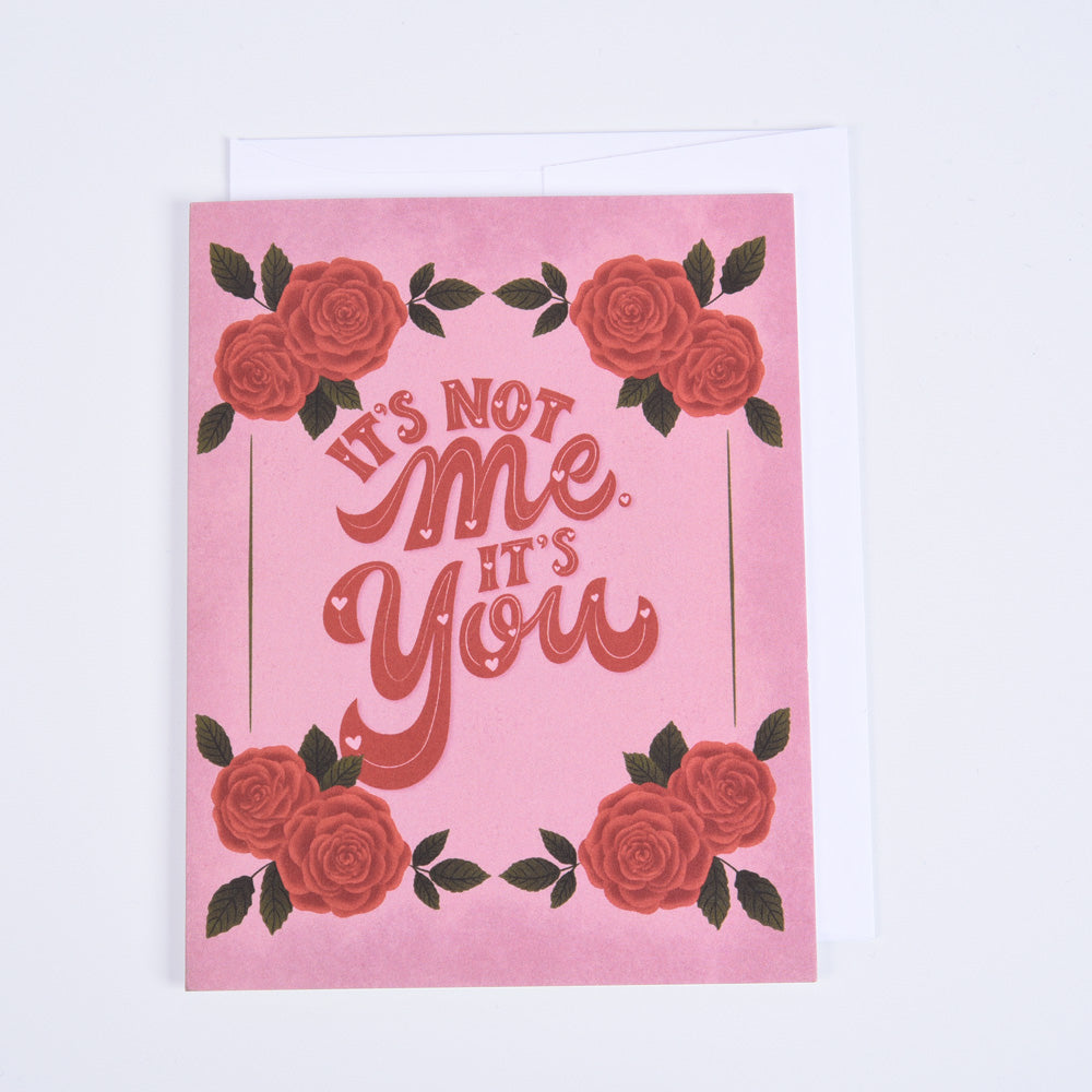 A pink greeting card with the text &