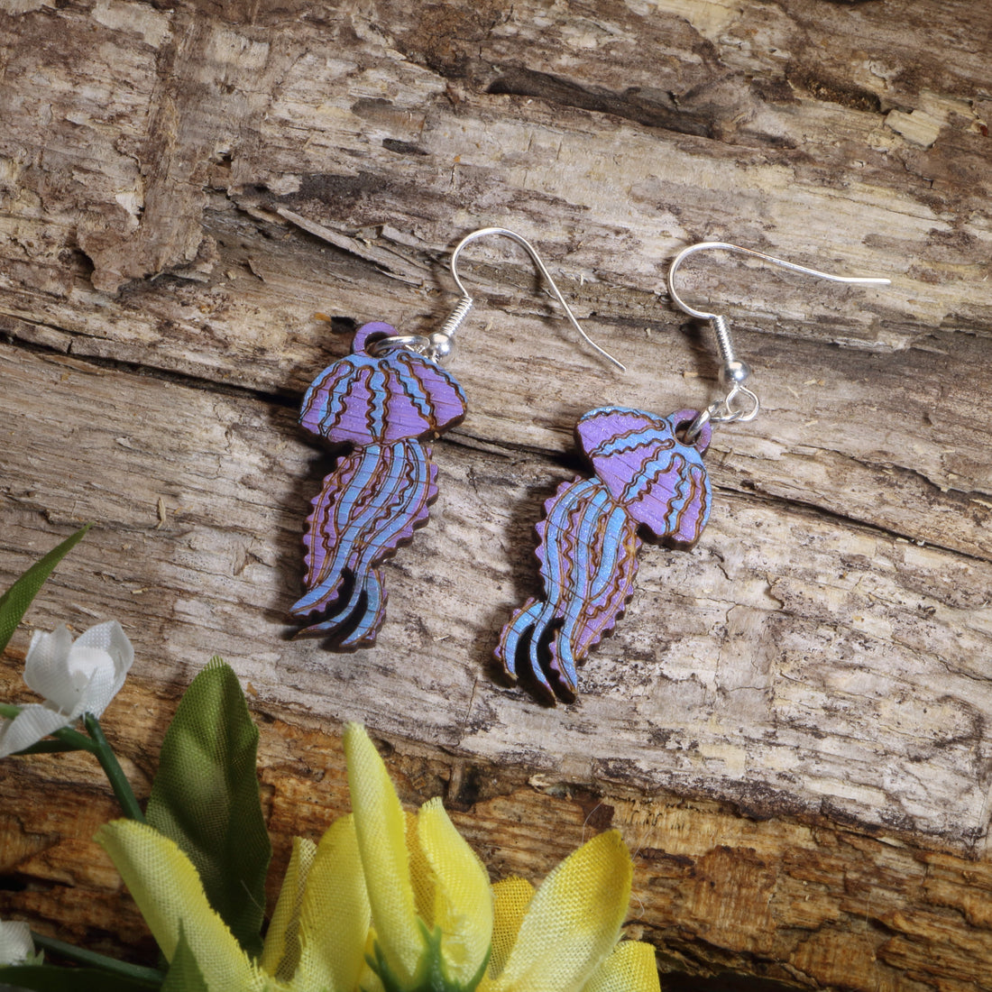 Hand-painted wooden jellyfish dangle earrings with purple and blue ocean-inspired design, hypoallergenic sterling silver hooks, and lightweight marine life jewelry for beach lovers and coastal style by Cate’s Concepts.