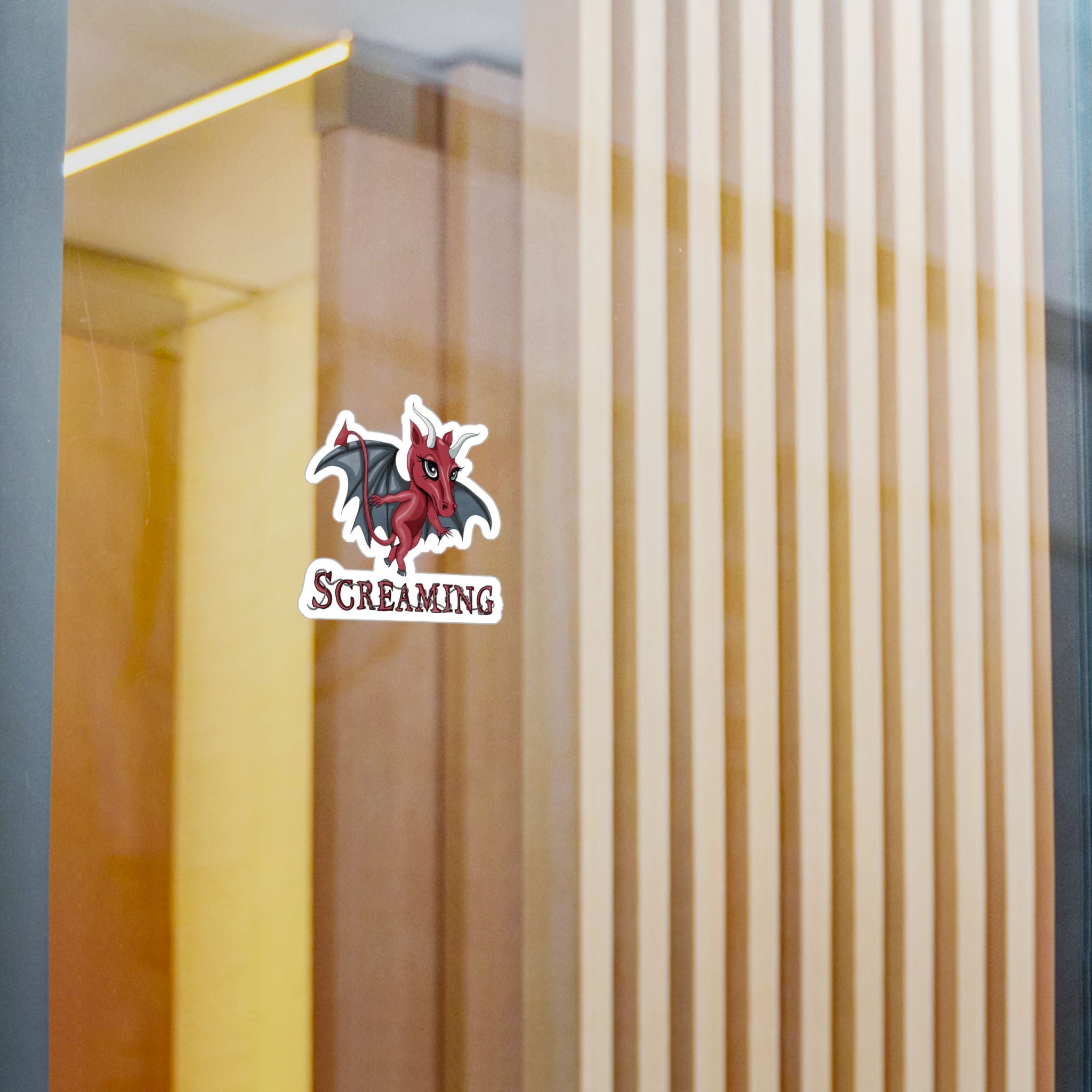 Small Jersey Devil cryptid sticker on a glass window in a modern interior