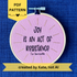 PDF pattern created by Kate, not AI. "Joy is an act of resistance" - Toi Derricotte. Text is a handwriting font and hand embroidered in black embroidery thread. Words are centered in a burst of golden, metallic rays. Fabric is light pink cotton. Framed as wall art or christmas ornament in light wood embroidery hoop.