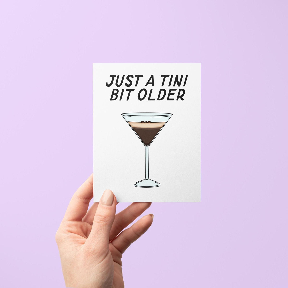 Just a tini bit older card flat lay — illustrated cocktail birthday card for a martini lover by indie artist MangoIllustrated
