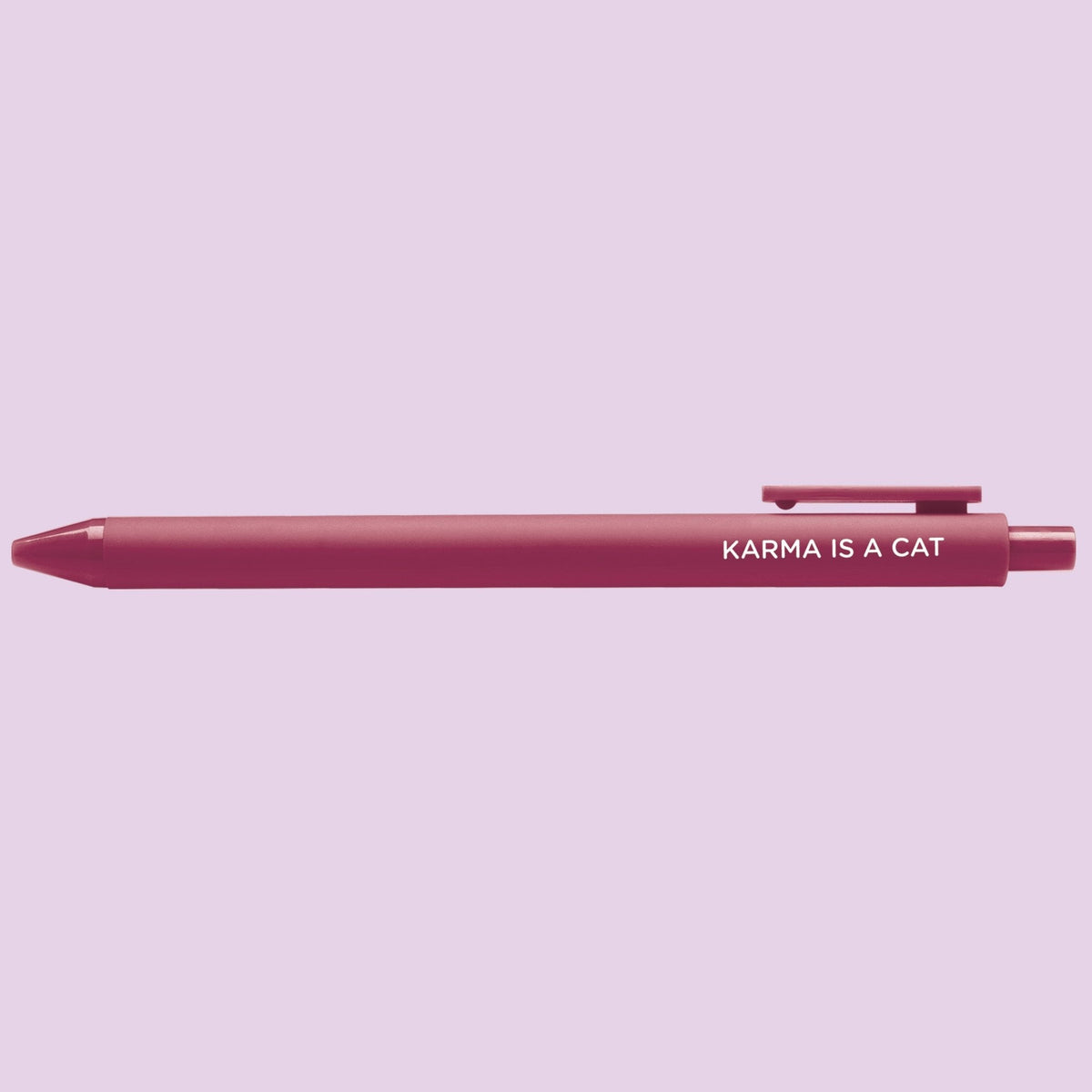 Karma is a Cat pen detail — printed cat phrase on the barrel, shown on a light purple background, by indie artist MangoIllustrated