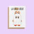 Halloween greeting card with the words “La-BOO-boo” and an illustration of a cute monster in a ghost costume with bunny ears.