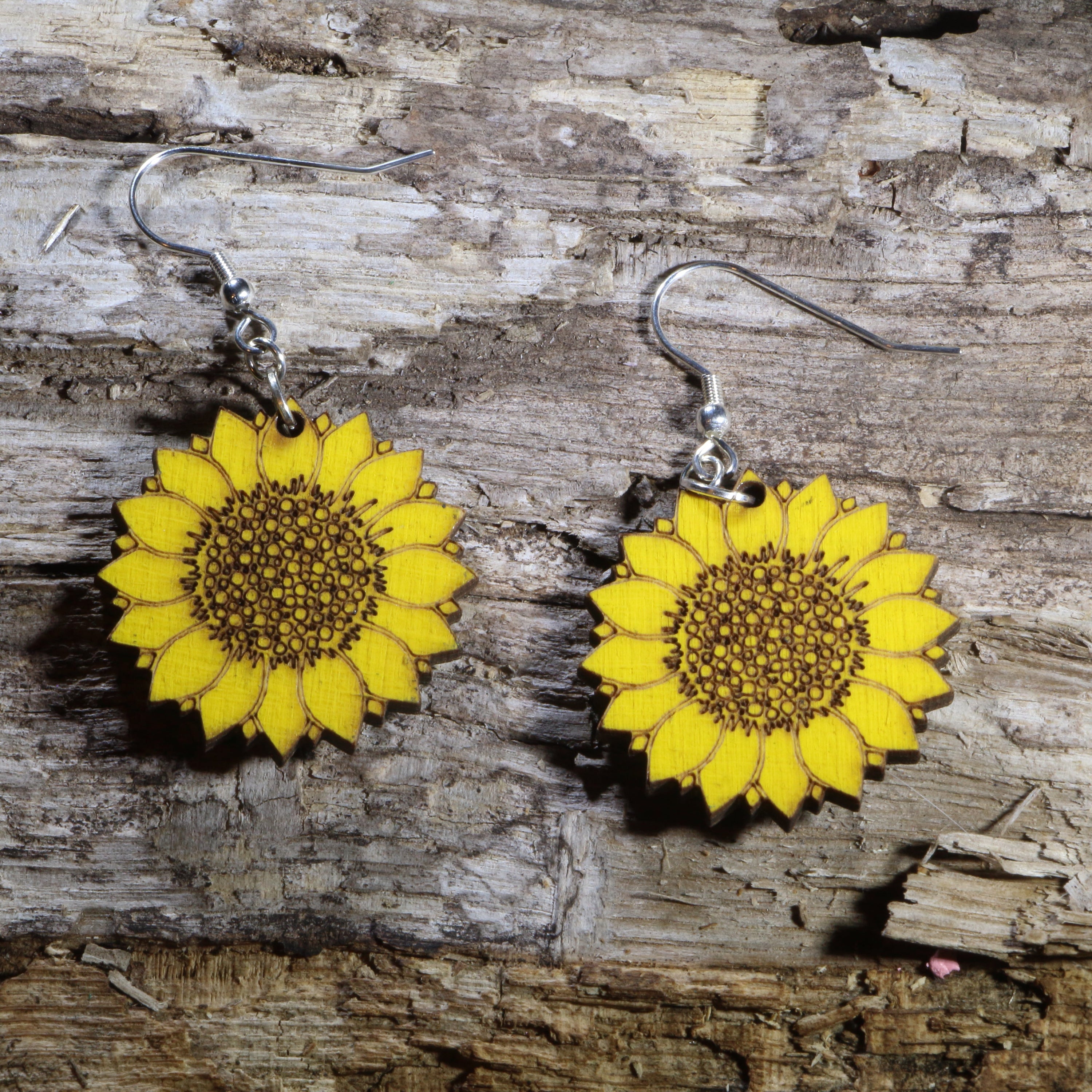 Hand-painted wooden sunflower dangle earrings featuring vibrant yellow sunflower artwork, hypoallergenic sterling silver hooks, and lightweight floral jewelry for gardeners, sunflower lovers, and nature-inspired everyday style by Cate’s Concepts.