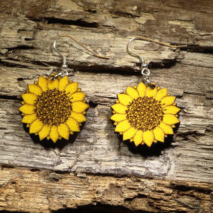 Hand-painted wooden sunflower dangle earrings featuring vibrant yellow sunflower artwork, hypoallergenic sterling silver hooks, and lightweight floral jewelry for gardeners, sunflower lovers, and nature-inspired everyday style by Cate’s Concepts.
