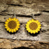 Hand-painted wooden sunflower dangle earrings featuring vibrant yellow sunflower artwork, hypoallergenic sterling silver hooks, and lightweight floral jewelry for gardeners, sunflower lovers, and nature-inspired everyday style by Cate’s Concepts.
