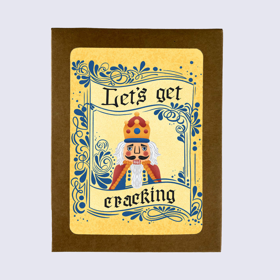Greeting card with a cartoonish nutcracker character in a crown and robe, with the phrase &