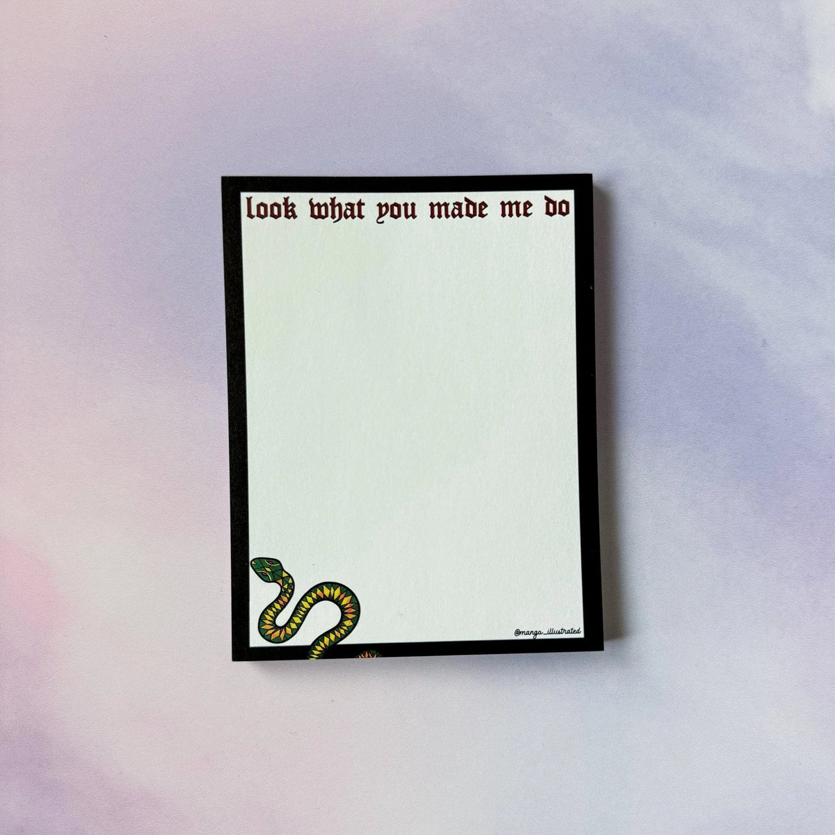 Look What You Made Me Do notepad detail — dark red hand lettering on a black border by indie artist MangoIllustrated