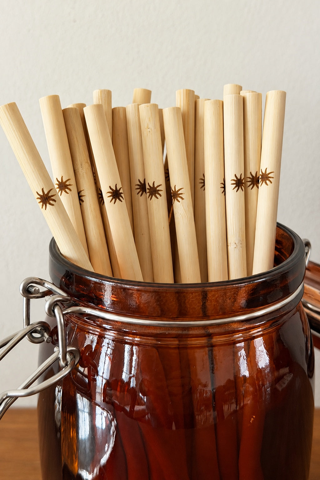 Jar filled with bamboo straws with star patterns on a neutral background