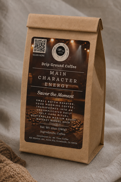 A kraft paper coffee bag standing upright on a draped fabric surface. The front label reads &