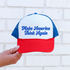 A red, white, and blue trucker hat with the text &