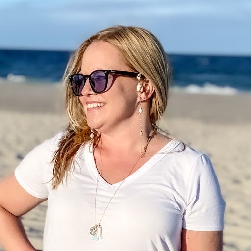 mantoloking charm necklace with white opal pendant freshwater stick pearl and starfish charm on model  standing on beach