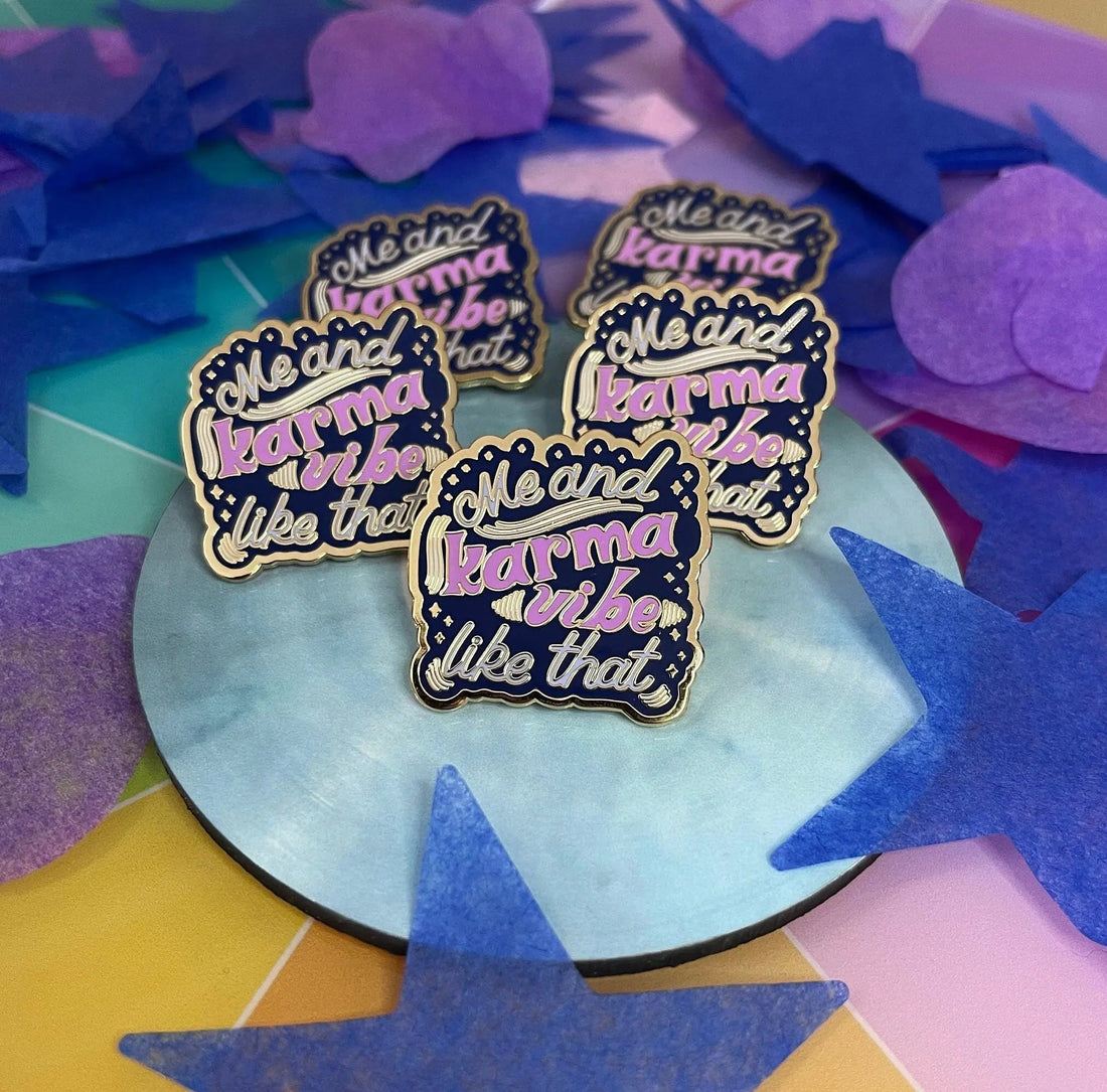 Me and Karma Vibe Like That enamel pin flat lay — hard enamel lapel pin with gold plating by indie artist MangoIllustrated