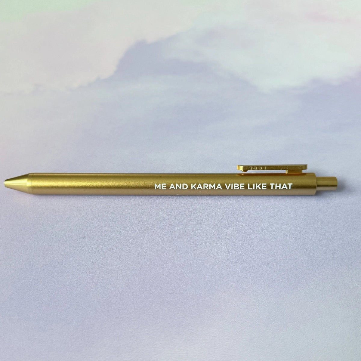 Me and Karma Vibe Like That jotter gel pen flat lay — gold barrel Midnights era desk pen by indie artist MangoIllustrated