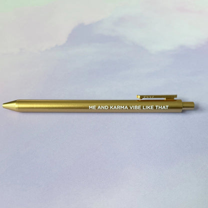 Me and Karma Vibe Like That jotter gel pen flat lay — gold barrel Midnights era desk pen by indie artist MangoIllustrated