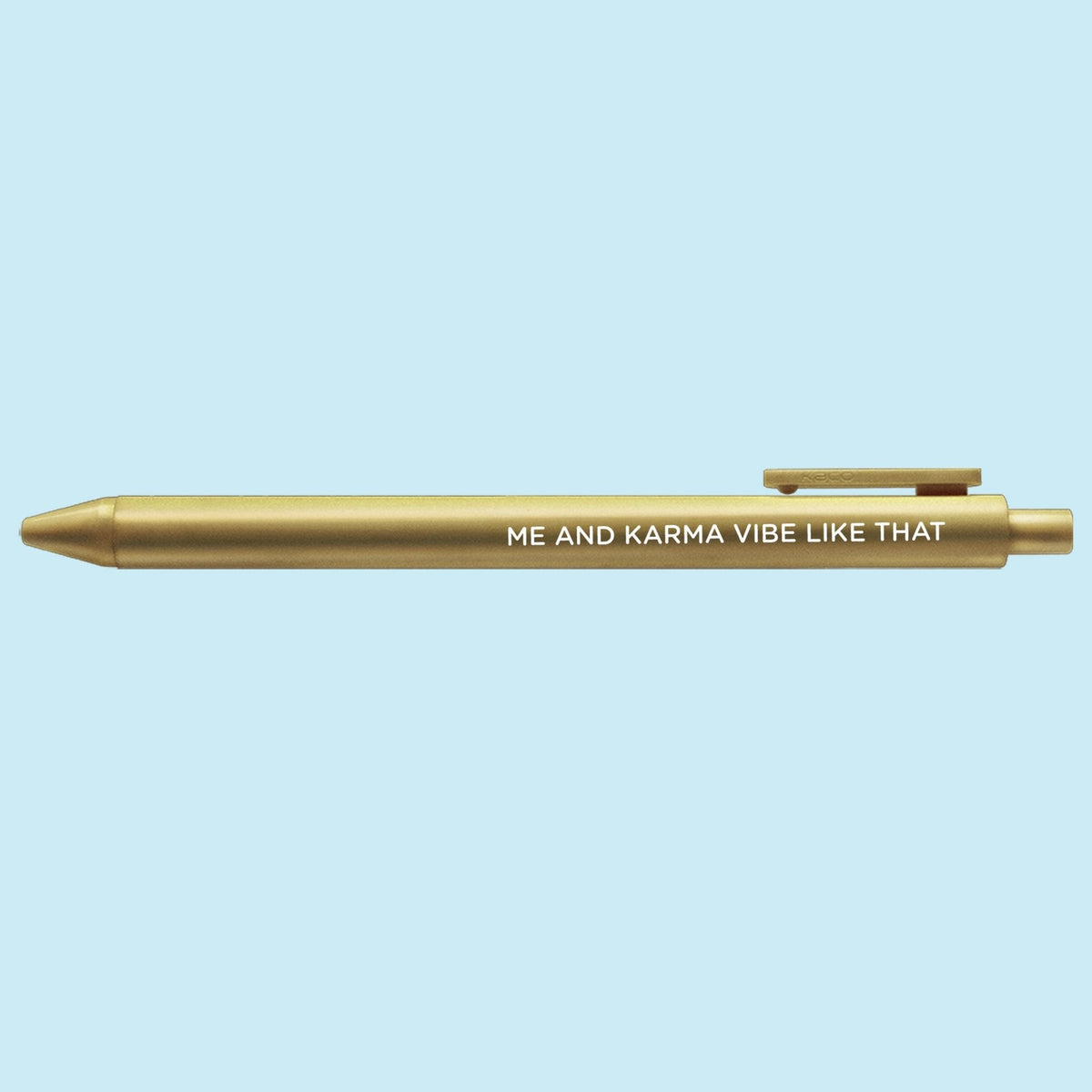Me and Karma Vibe Like That jotter gel pen detail — close up of the embossed lettering on the gold barrel by MangoIllustrated