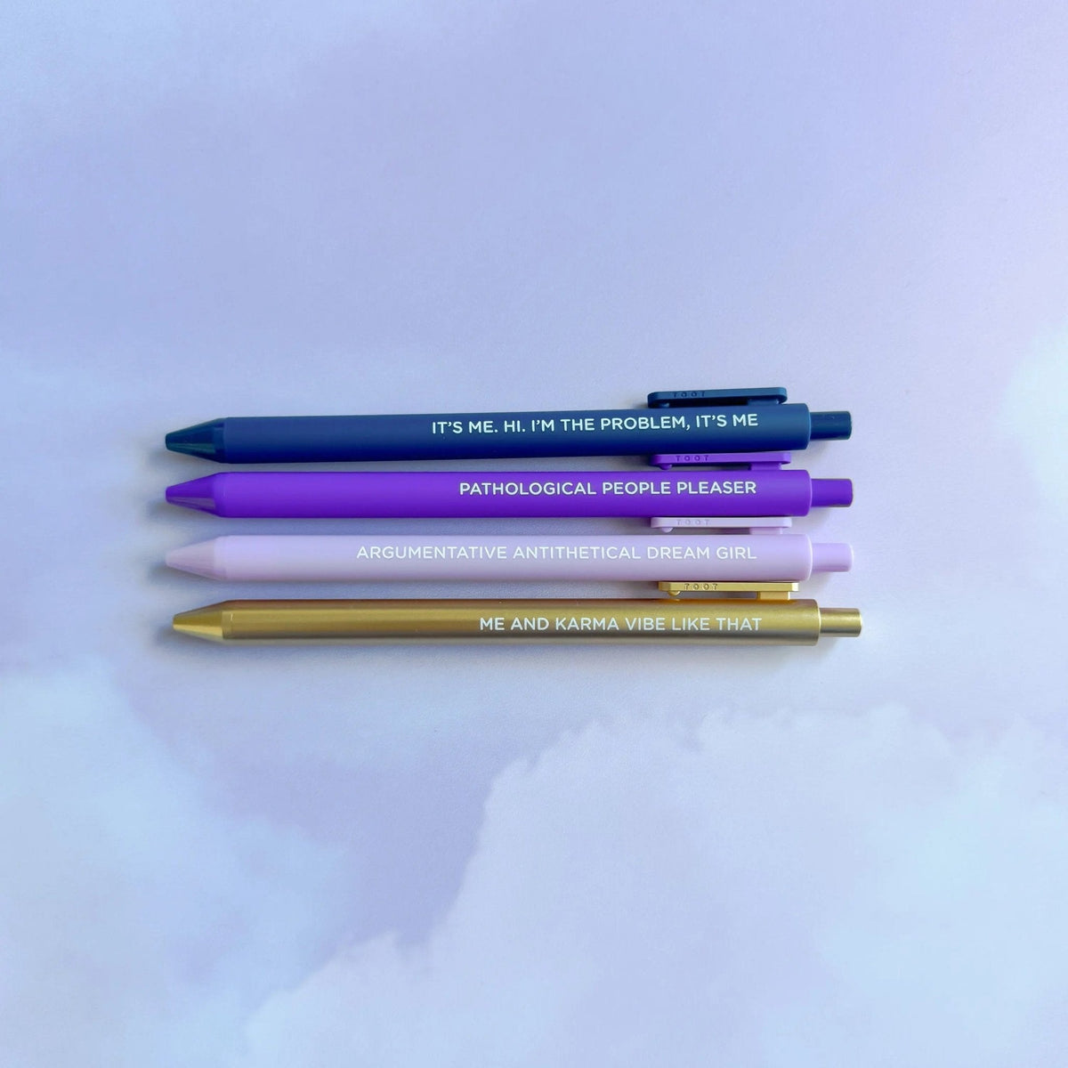 Midnight Musings Pen Set detail — embossed lettering on the purple and lavender pen barrels by indie artist MangoIllustrated