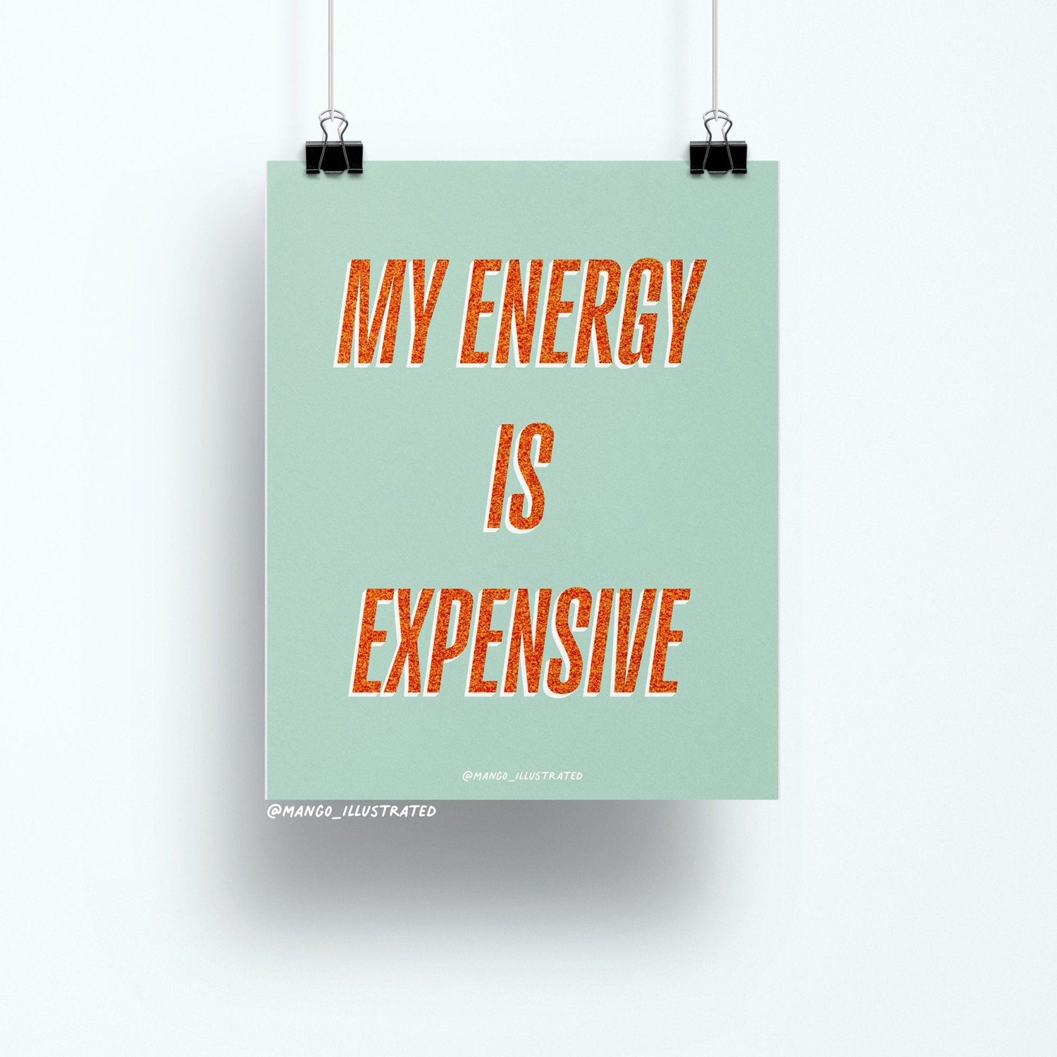 8x10 art print with bold orange glitter-style text reading “My Energy is Expensive” on a mint green background, printed on matte paper and packaged with cardboard backing in a cellophane sleeve.