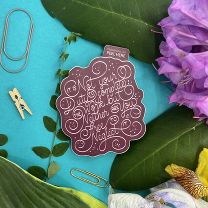 Decorative sticker with ornate lettering that reads "it is not your duty to complete the work but neither are you free to neglect it" on a styled background with flowers and paper clips