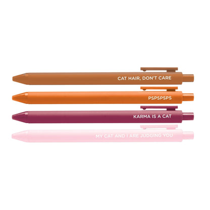 Set of four colorful pens with cat-themed quotes: “Cat Hair, Don’t Care,” “PSPSPSPS,” “Karma is a Cat,” and “My Cat and I Are Judging You."
