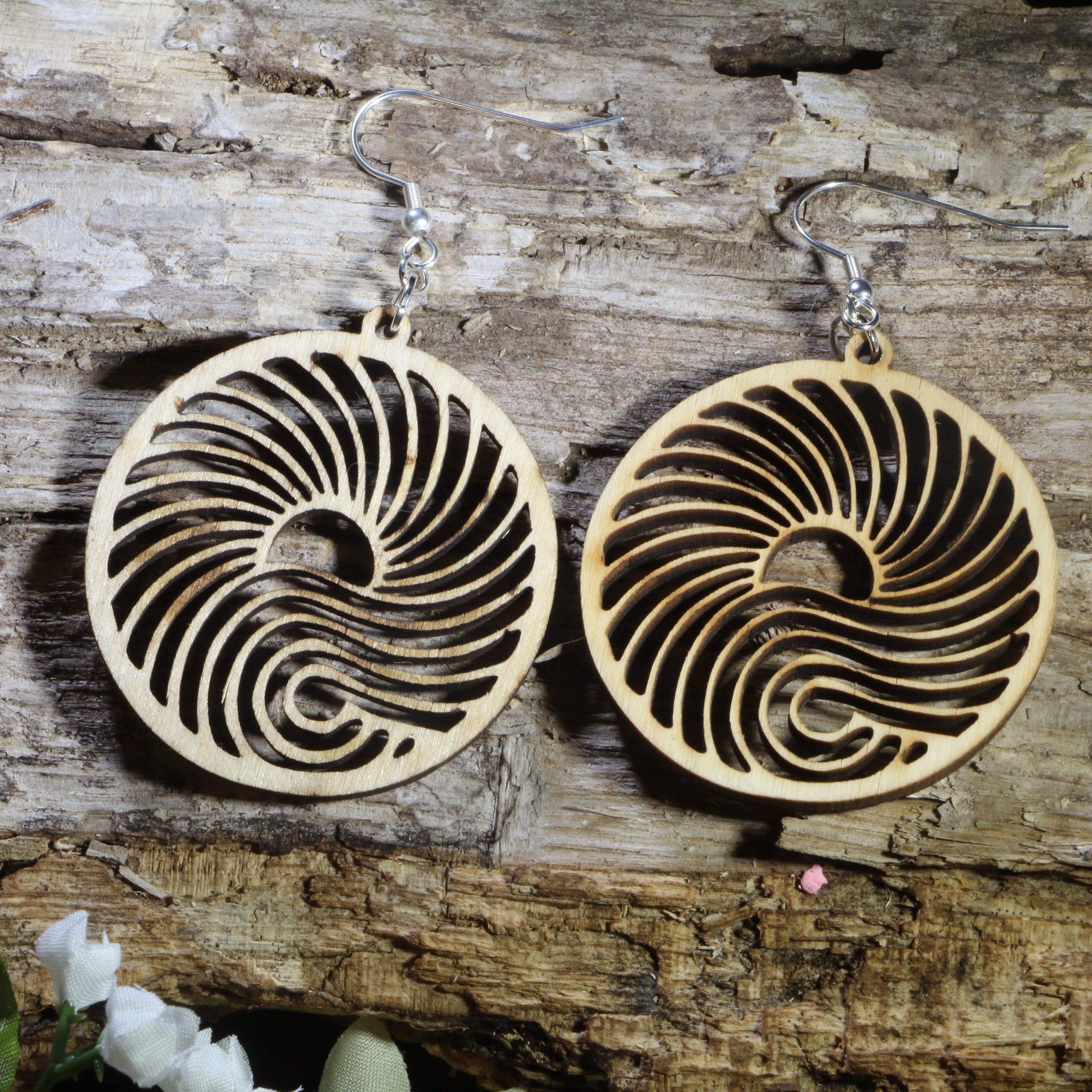Hand-painted wooden ocean wave dangle earrings featuring an intricate swirling wave design inspired by the sea. Crafted from lightweight wood with hypoallergenic .925 sterling silver hooks, these artistic nautical earrings are perfect for beach lovers, surfers, ocean enthusiasts, coastal vacations, marine life fans, and anyone who loves elegant seaside-inspired jewelry with a natural coastal aesthetic.