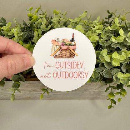 hand holding sticker with text "I&