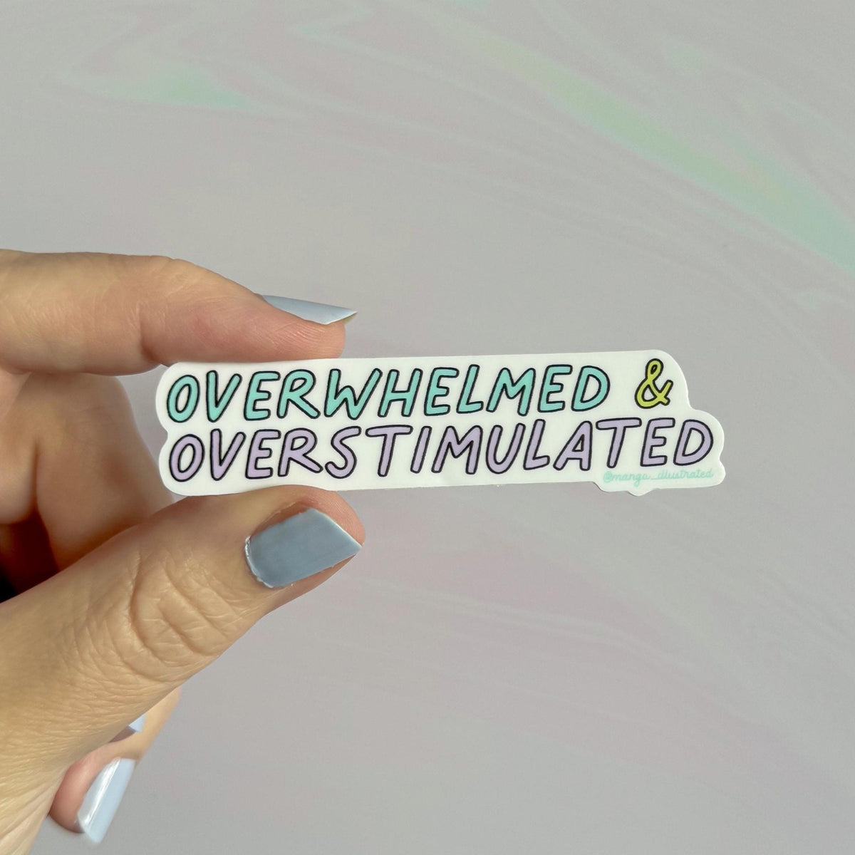 Overwhelmed and overstimulated sticker second detail — purple, blue and green lettering close up by indie artist MangoIllustrated