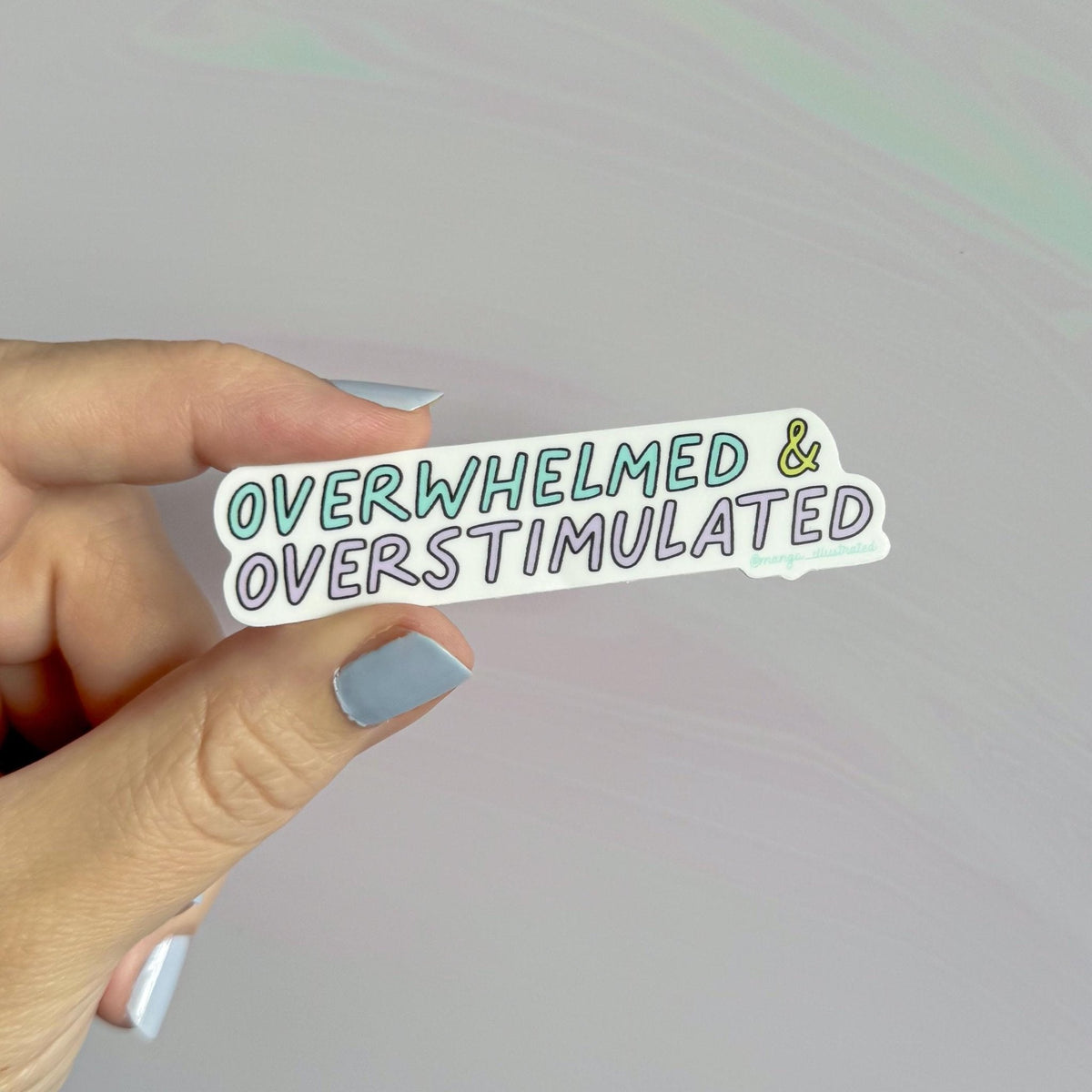 Overwhelmed and overstimulated sticker detail — close up of the hand lettered design by indie artist MangoIllustrated