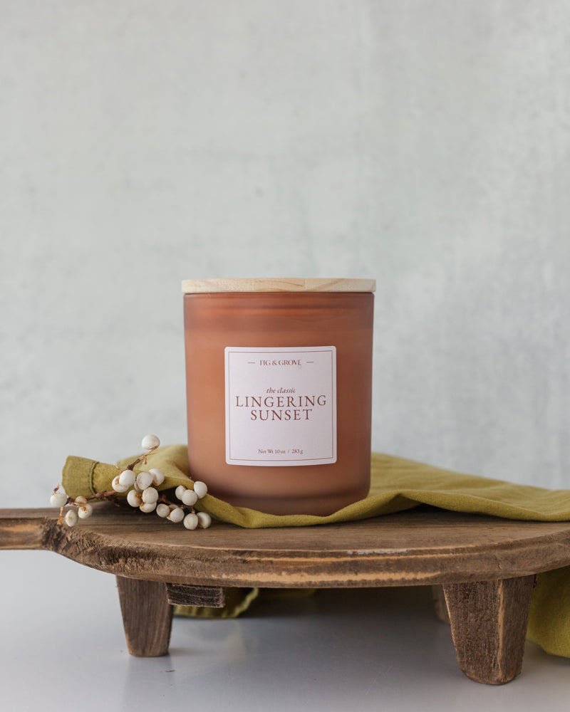 Hand-poured Lingering Sunset candle featuring pear, peach, papaya, and plum notes