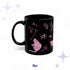 11 oz hot pink Victorian goth mug with a seated black cat, a skull, loose bones, and a rose on glossy black ceramic