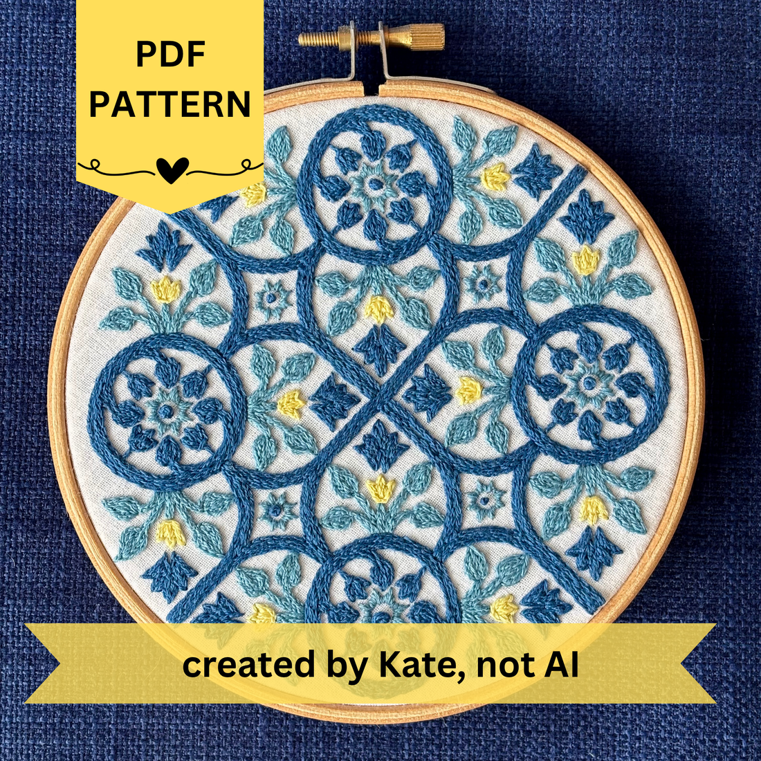 PDF Pattern created by Kate, not AI. Dark blue, light blue, and yellow embroidery based on traditional Portuguese tile with flowers, leaves, lines, and stars. Fabric is white on white cotton. Embroidery is displayed as wall art in light wood embroidery hoop.
