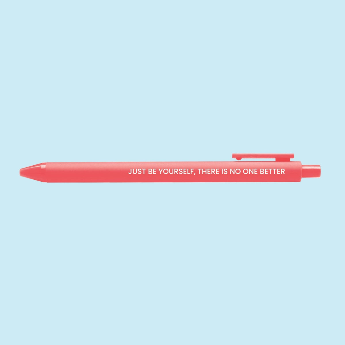 Just Be Yourself pen flat lay — neon coral motivational gel pen for desk and journaling by indie artist MangoIllustrated