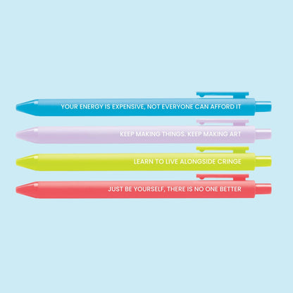 Set of four colorful pens with motivational affirmations, including “Your energy is expensive,” “Keep making art,” “Live alongside cringe,” and “Just be yourself.”