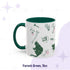 Forest green 11oz preppy skull and bones mug, pink and green gothic scatter of skulls, bones, a raven, and a skeletal hand with a steaming teacup