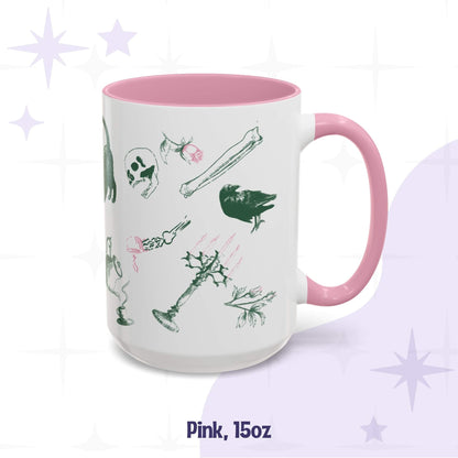 Pink 15oz preppy skull and bones mug, green and pink scatter of a black cat, a skull, a raven, roses, and a candelabra on white