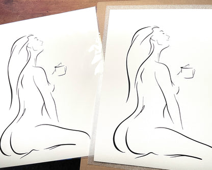 Black and white elegant line art illustration of a sensual woman enjoying her first cup of coffee, head tilted back, in a peaceful pose, titled "But First, Coffee"; black frame on white wainscoting with modern black decor; printed on Aquarelle Rag paper, packaged for shipping.