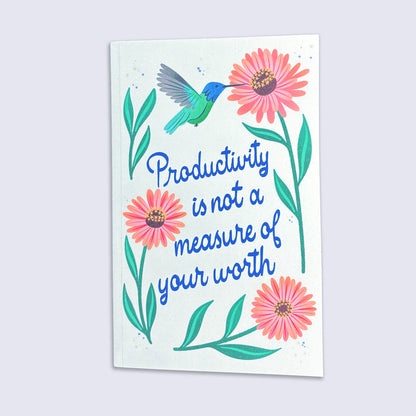 journal with a hummingbird, flowers, and the quote &