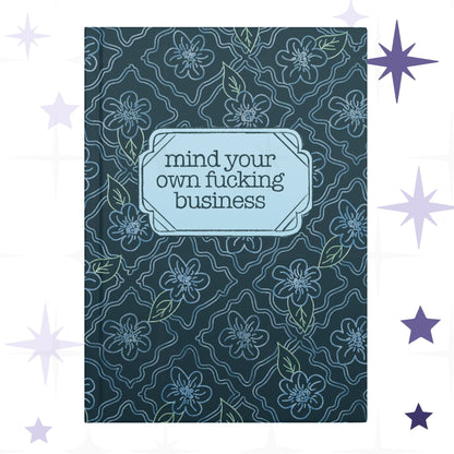 Profanity floral hardcover journal with teal botanical pattern and vintage label reading mind your own fucking business in retro serif type