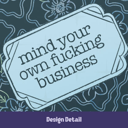 Close-up detail of vintage label reading mind your own fucking business in retro serif type on teal floral hardcover journal