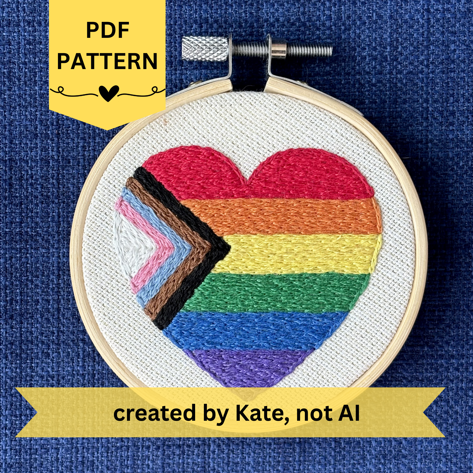PDF pattern created by Kate, not AI. Heart-shaped progress pride flag hand embroidered onto cream colored linen. Displayed in a light wooden embroidery hoop as wall art or a christmas ornament.