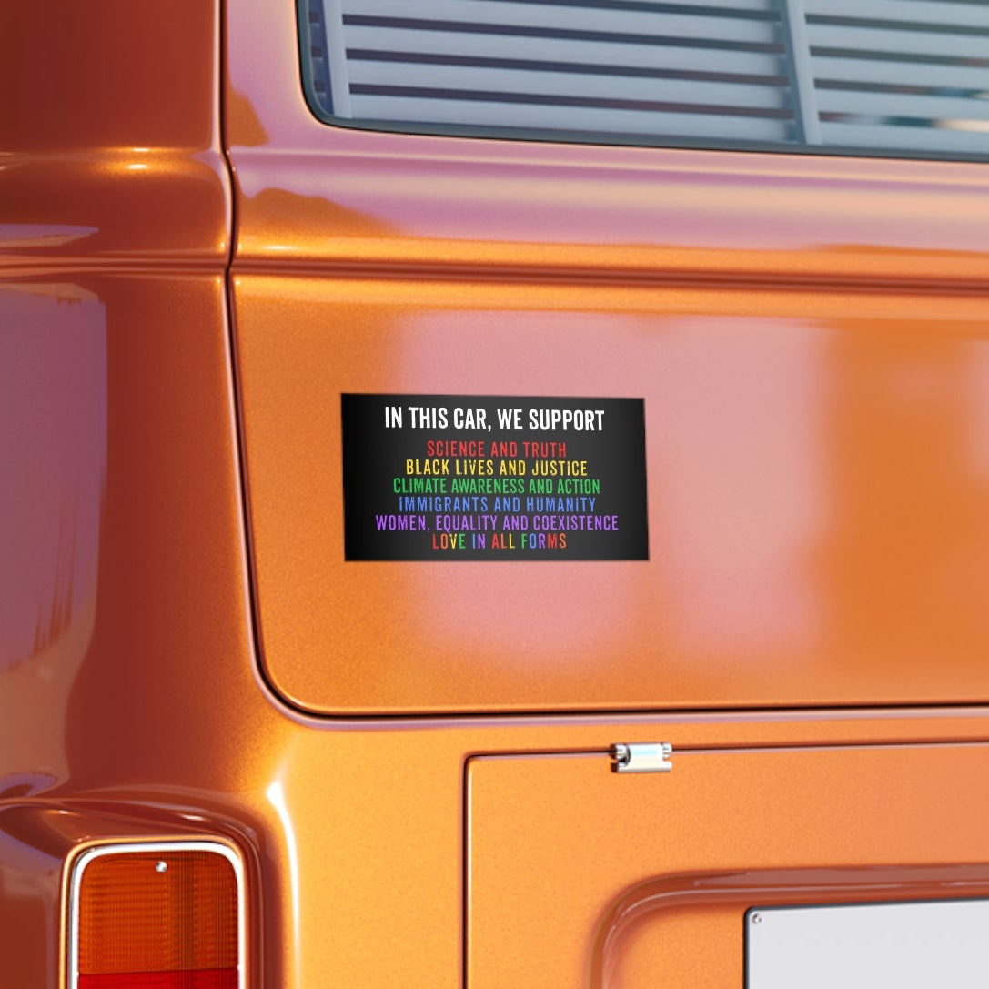 Close-up of an orange vehicle with a progressive bumper sticker