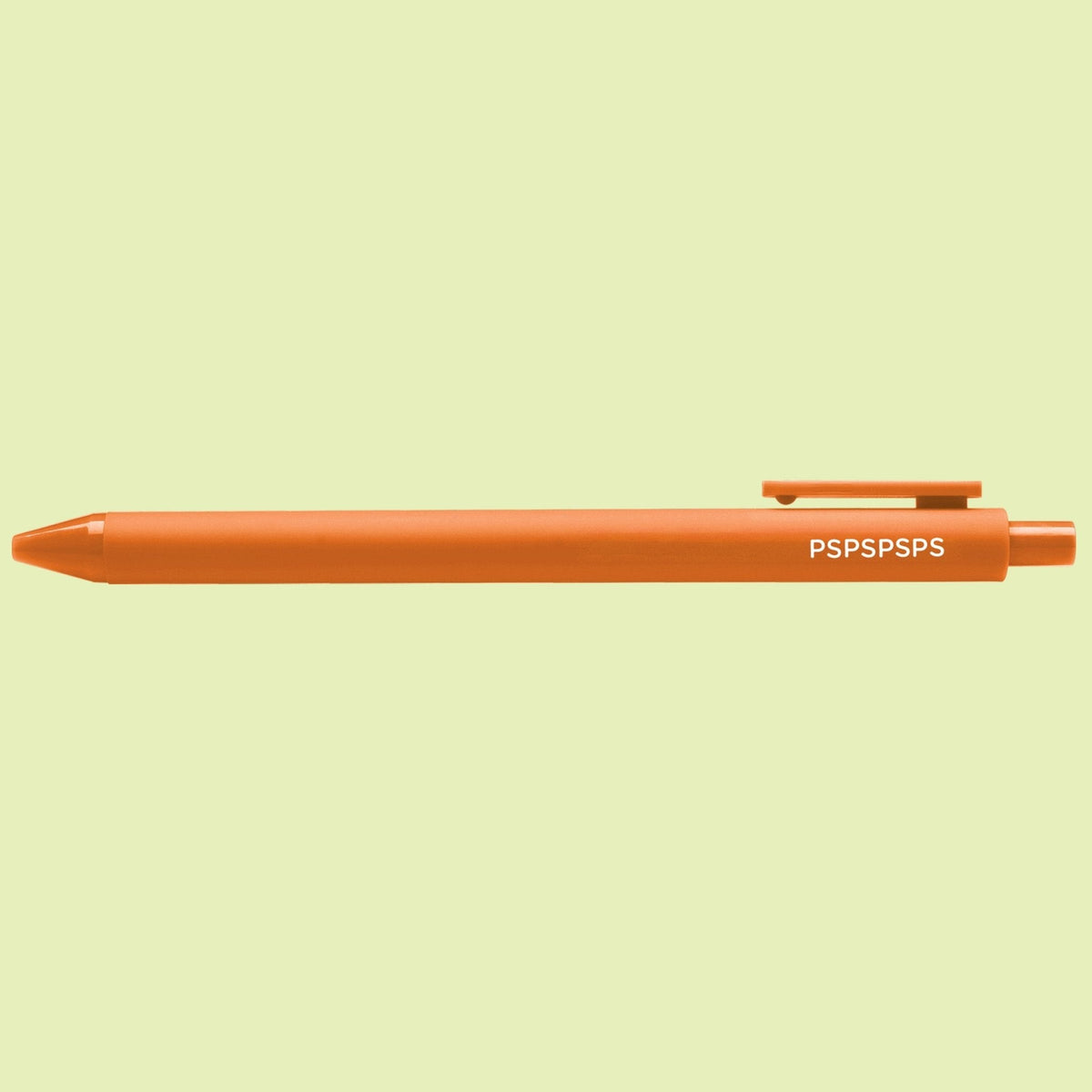 PSPSPSPS pen flat lay — orange jotter gel pen on a light green background by indie artist MangoIllustrated