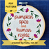PDF pattern. Created by Kate, not AI. "Pumpkin spice and human rights". Handwriting font text hand embroidered in two shades of medium orange. Surrounded by a floral wreath of bright pink asters with yellow centers and green leaves and stems. Framed in light wood embroidery hoop and displayed as wall art.