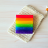 Rainbow striped soap on a textured white background