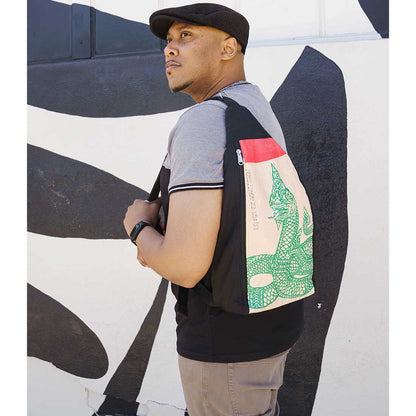 man wearing recycled backpack with cool serpent design
