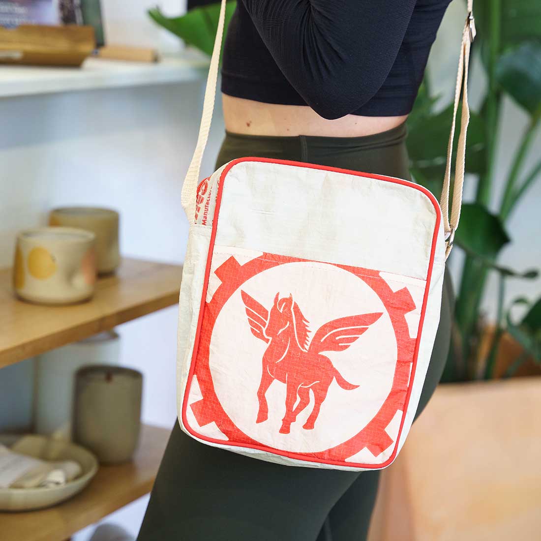 woman wearing red elephant recycled crossbody bag