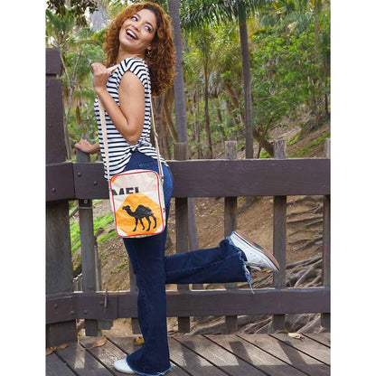 Woman  in the park wearing recycled crossbody purse - camel design
