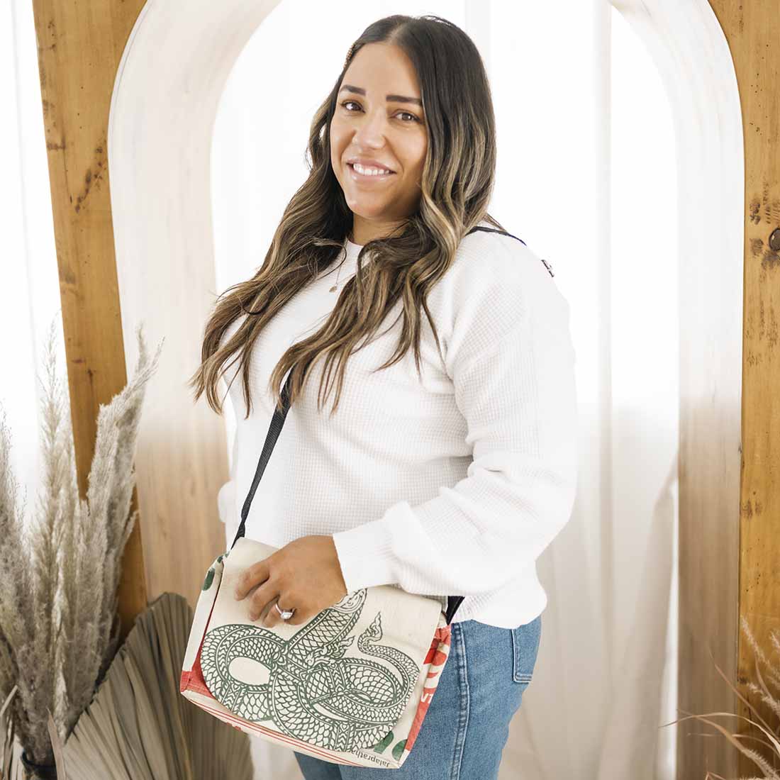 woman wearing sustainable messenger - serpent design