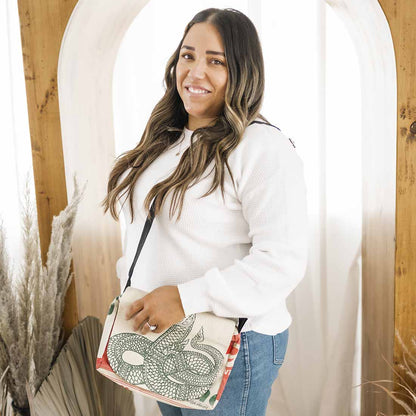 woman wearing sustainable messenger - serpent design