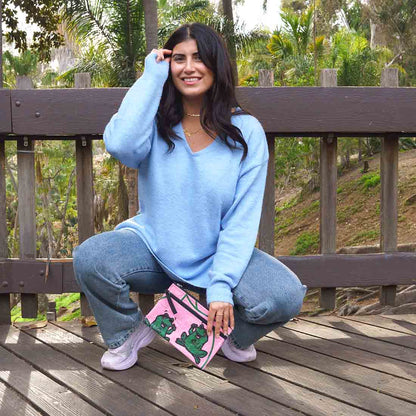 girl holding frog print pouch